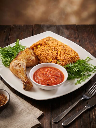 Jollof-rice-with-quarter-chicken-and-spicy-sauce at aircuisinedishes